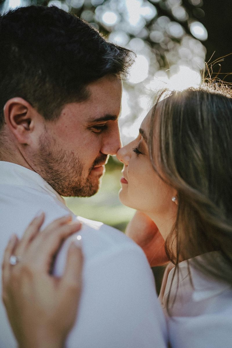 Engaged couple nose to nose in golden light