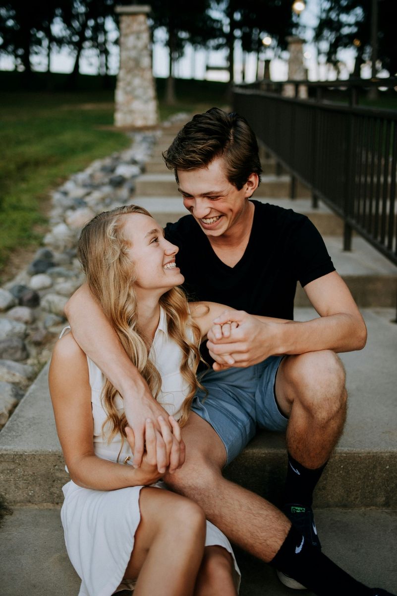 Couple laughing together on outdoor steps